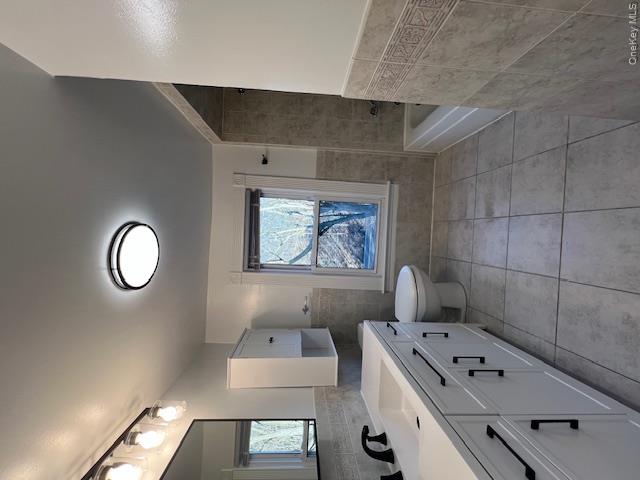 418 Christian Herald Road, Unit 4 Valley Cottage, NY 10989 - Photo 9 of 16 a bathroom with a granite countertop sink a toilet and a bathtub