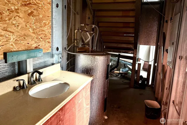 a bathroom with a sink a toilet and mirror