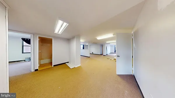 an empty room with windows and entrance