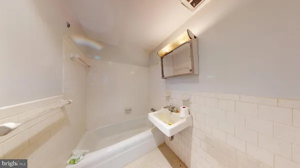 a view of a hallway with stairs and wooden floor
