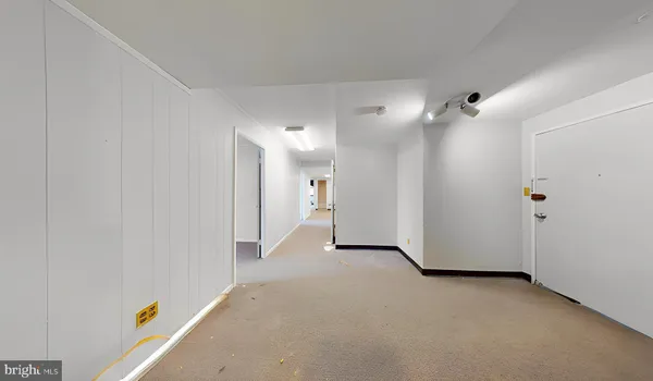 a view of a workspace with furniture and a book shelf