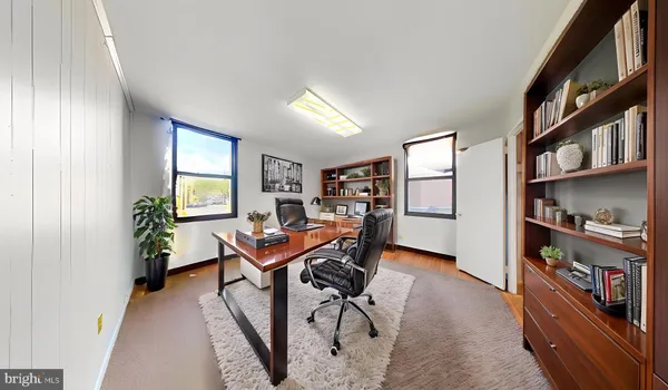 a workspace with furniture and bookshelf