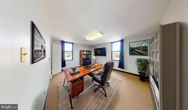 a view of a livingroom with furniture and a book shelf