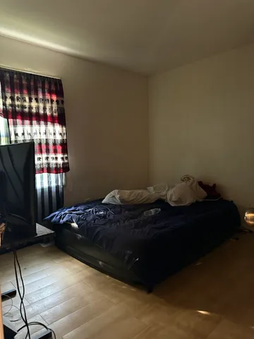 a bed sitting in a bedroom next to a window
