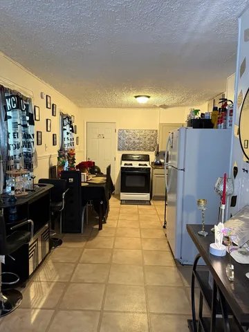 a kitchen with refrigerator and cabinets