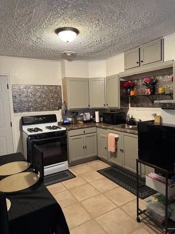 a kitchen with a sink appliances and cabinets