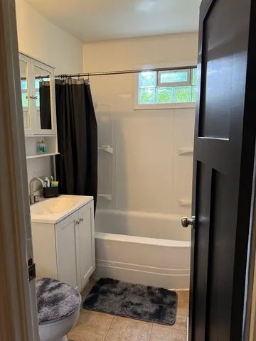 a bathroom with a bathtub a sink and a shower