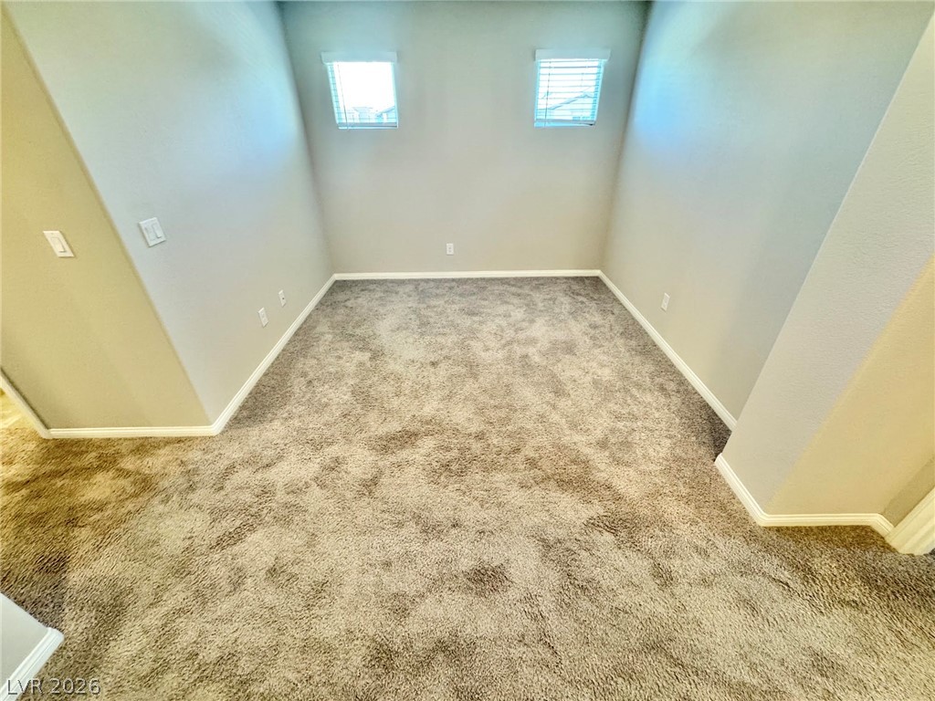 7020 Colonial Ranch Street Las Vegas, NV 89166 - Photo 33 of 37 Plush carpeting anchors this versatile alcove illuminated by high square windows.