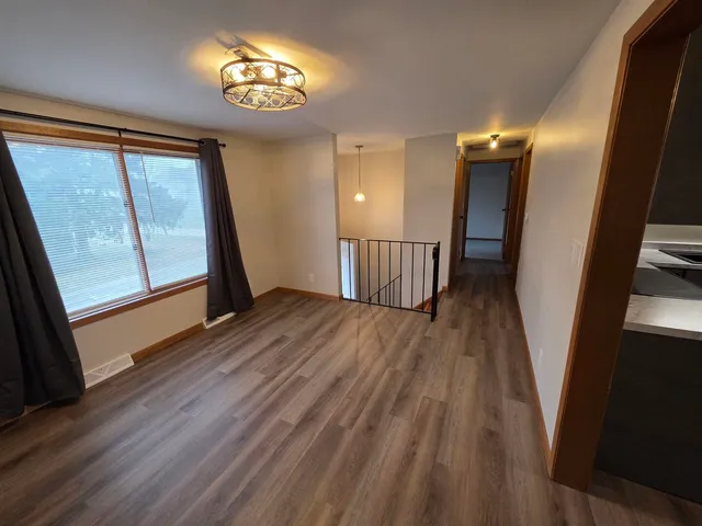 a view of a room with wooden floor and windows