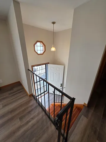 a view of entryway and hall with wooden floor