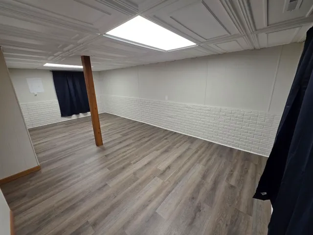 a view of an empty room with wooden floor