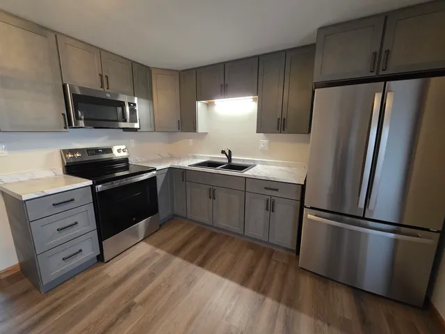 a kitchen with a refrigerator stove and sink