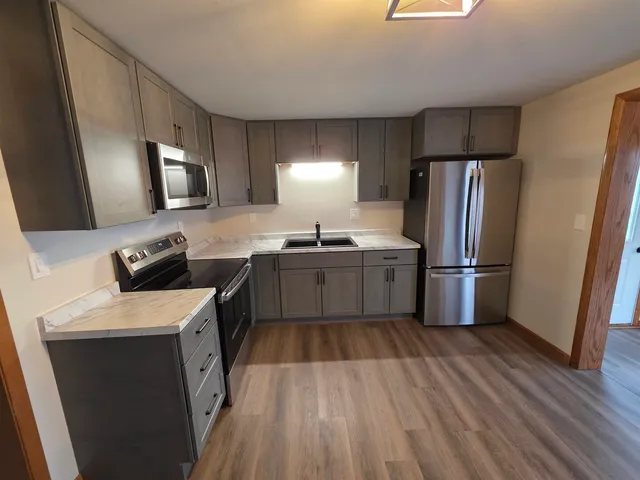a kitchen with a sink appliances and cabinets