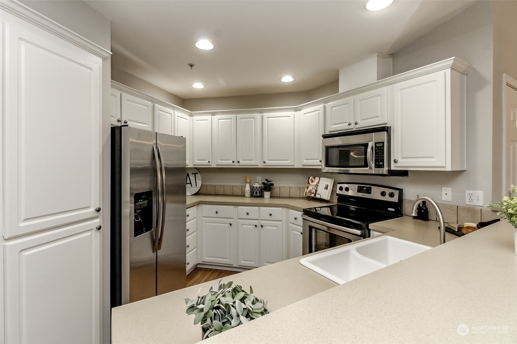 1607 Kincaid Street, Unit E8 DuPont, WA 98327 - Photo 11 of 28 a kitchen with stainless steel appliances granite countertop a refrigerator stove microwave and sink