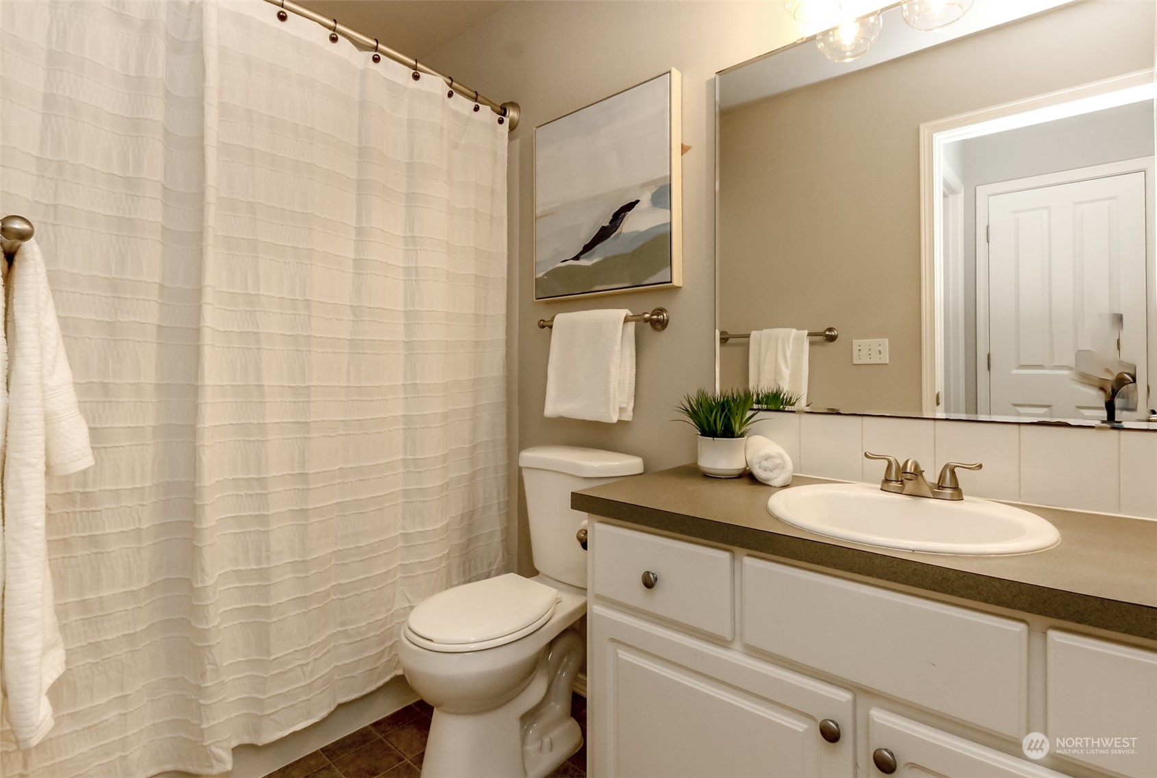 1607 Kincaid Street, Unit E8 DuPont, WA 98327 - Photo 19 of 28 a bathroom with a granite countertop toilet sink and mirror