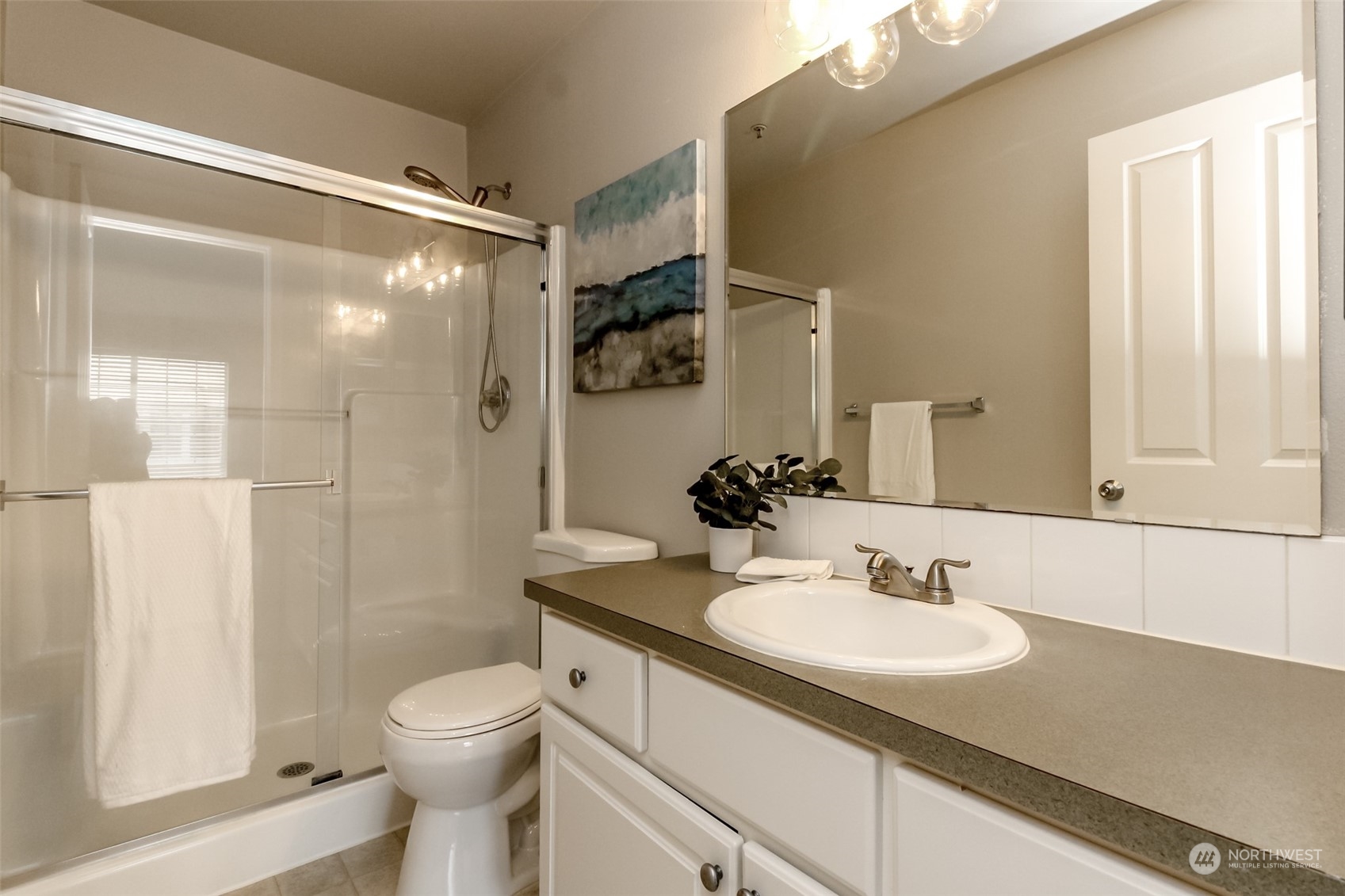 1607 Kincaid Street, Unit E8 DuPont, WA 98327 - Photo 22 of 28 a bathroom with a sink toilet and shower