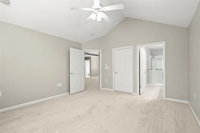 an empty room with fan and entrance