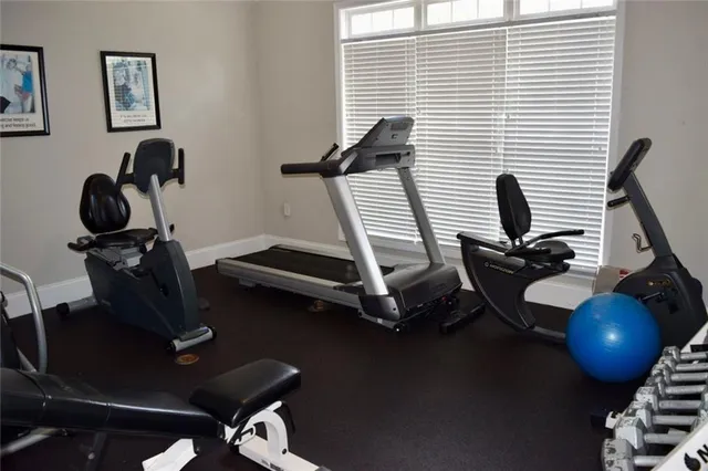 a living room with lots of furniture and a large window