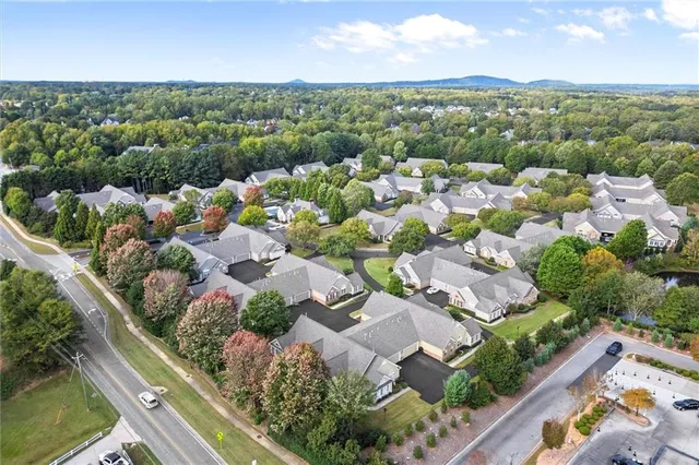 an aerial view of residential houses with outdoor space and river