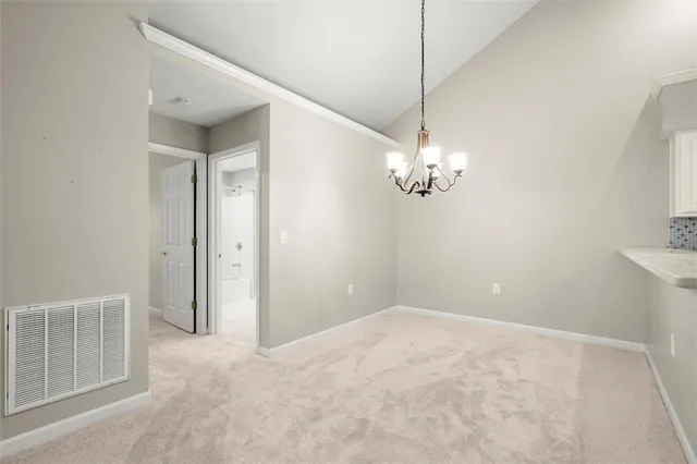 a view of a chandelier fan and refrigerator