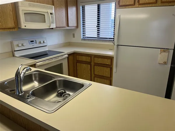a kitchen with a refrigerator sink and microwave