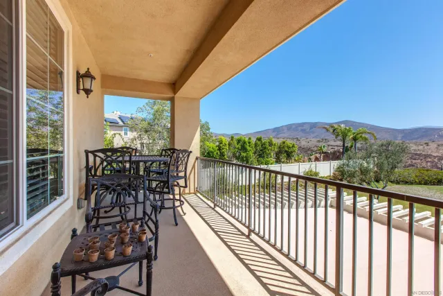 a view of a balcony with chairs