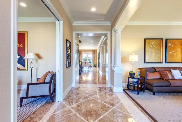 a living room with furniture a fireplace and a large window
