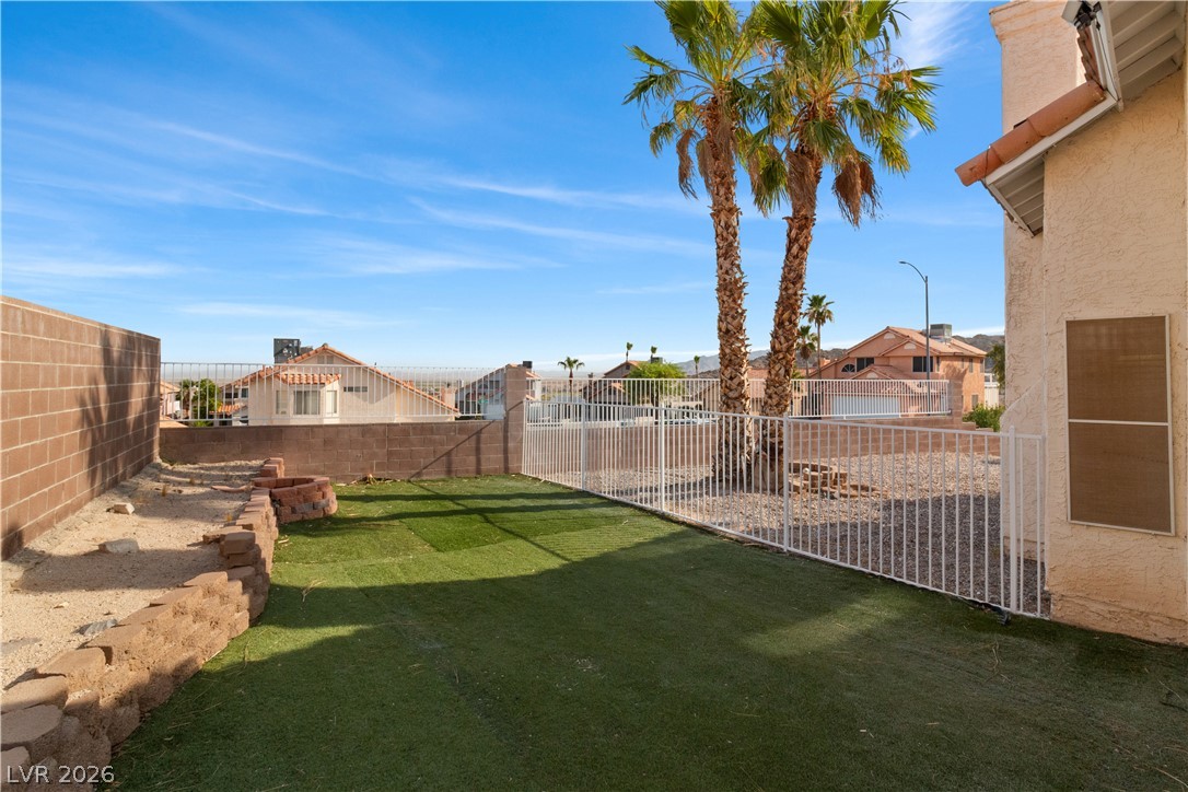 3156 Terrace View Drive Laughlin, NV 89029 - Photo 67 of 94 A well-maintained yard provides ample space for recreation, complemented by low-maintenance artificial turf.