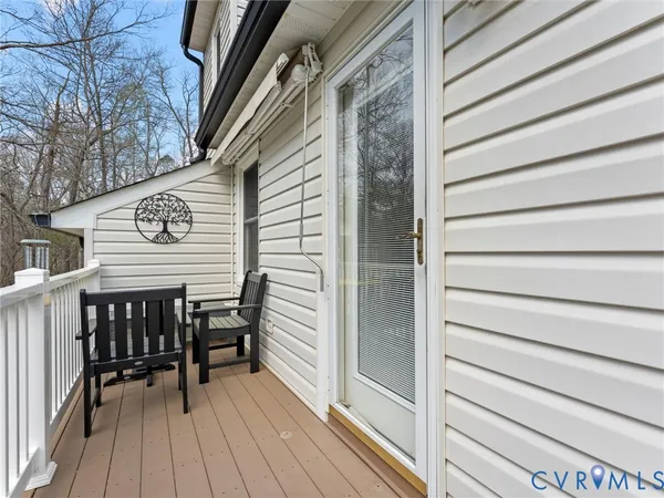 a view of a house with a yard and deck