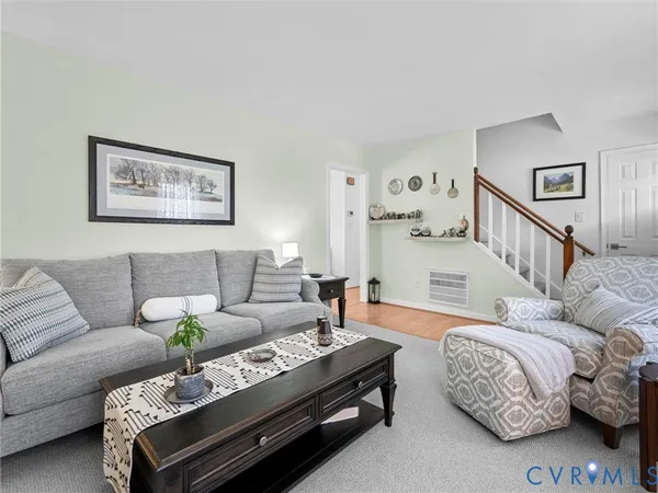 a living room with furniture and a table