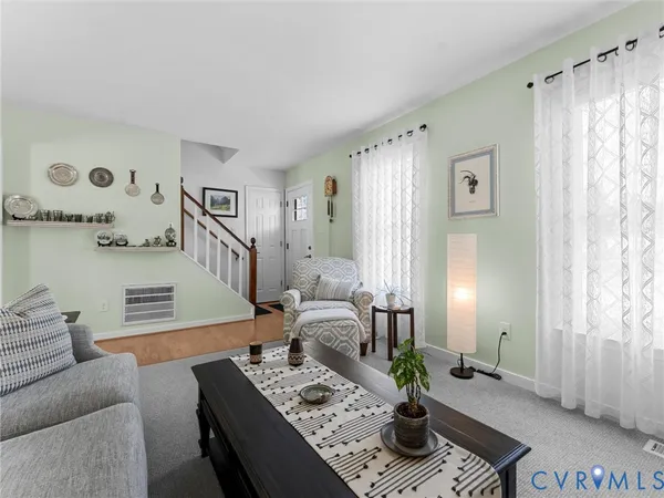 a living room with furniture and a rug