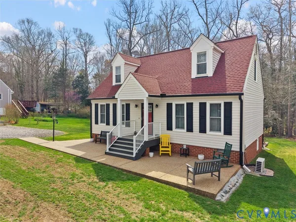 a view of a house with a yard patio and a slide