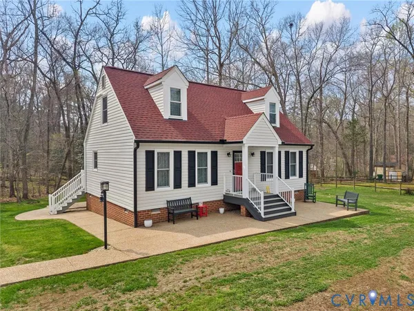 a view of a house with backyard porch and sitting area
