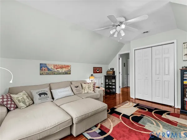 a living room with furniture and a book shelf