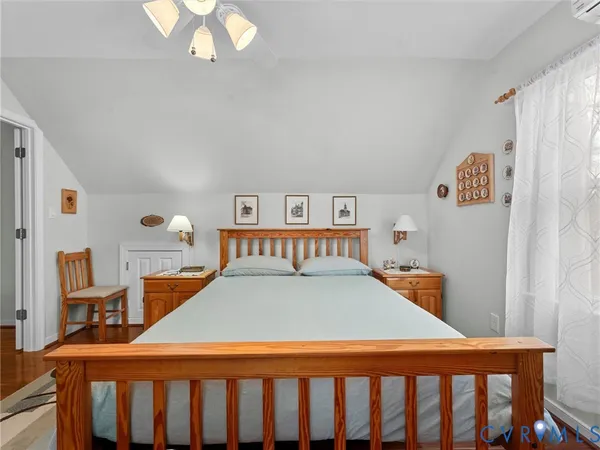 a bedroom with a large bed and a chandelier