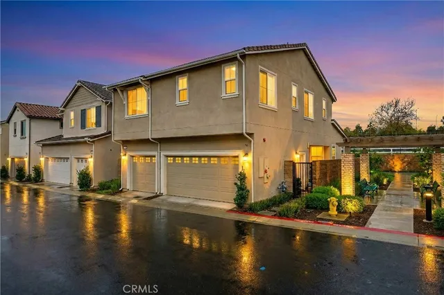 a front view of a house with lots of water and a yard