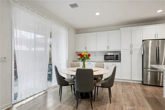 a dining room with furniture and wooden floor