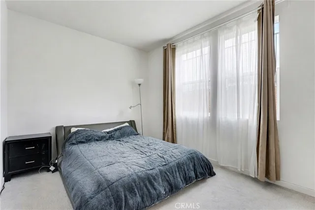 a view of a bedroom with wooden floor and closet