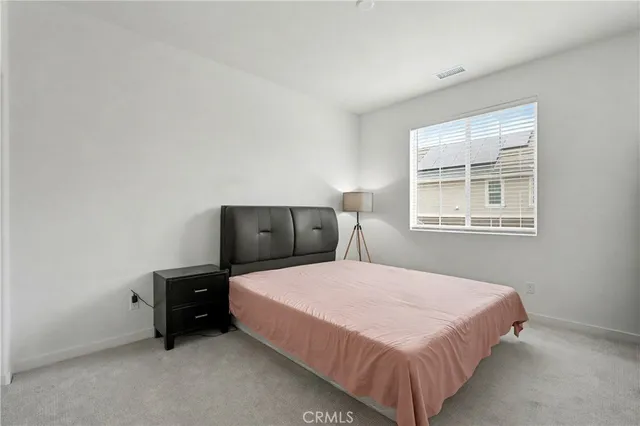 a bedroom with a bed and cabinet