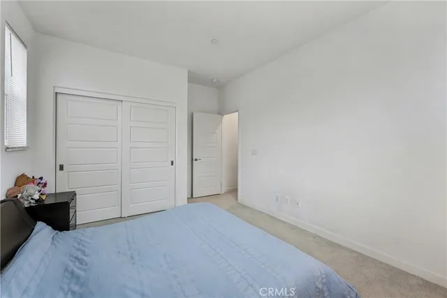 a bed room with a bed and a chair