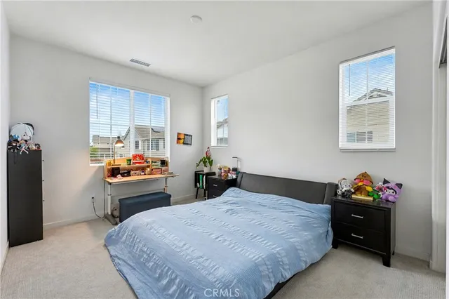 a bathroom with a granite countertop sink a toilet and a large mirror