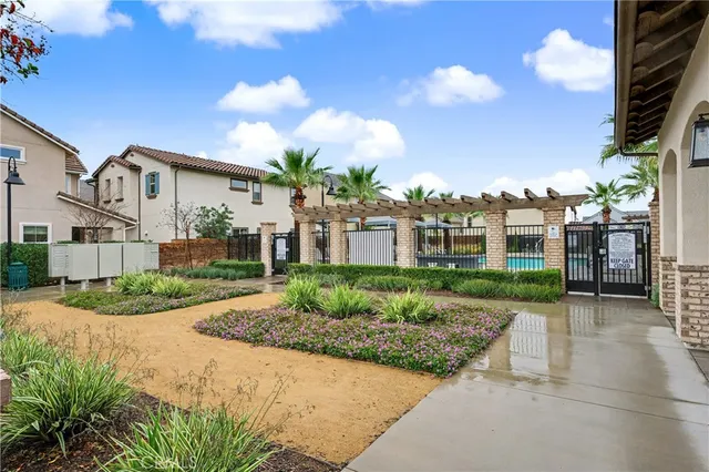 a view of a swimming pool with a lawn chairs under an umbrella
