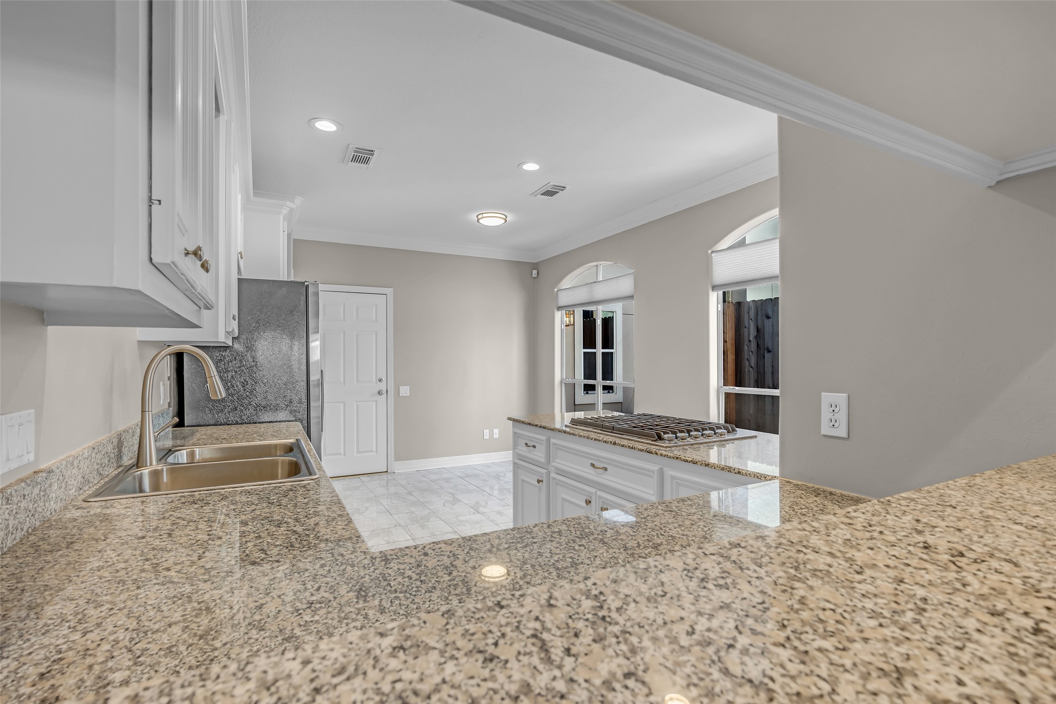 4916 Travis Street Houston, TX 77004 - Photo 12 of 27 a view of a kitchen with kitchen island granite countertop a refrigerator and a sink
