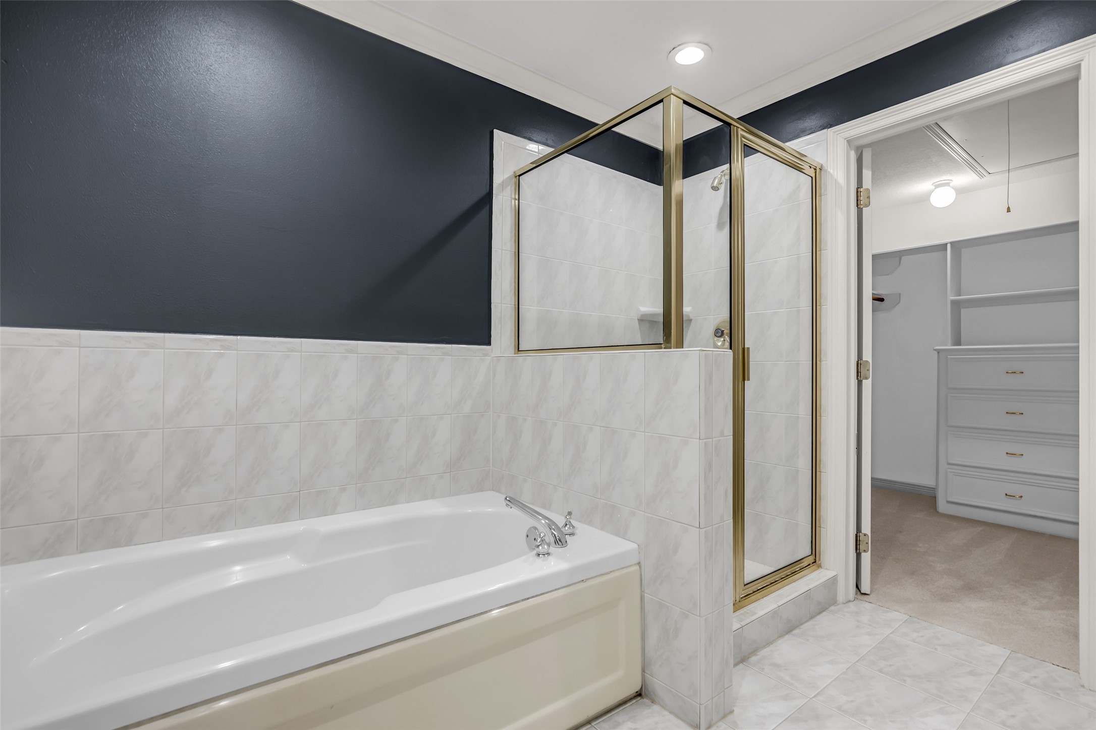 4916 Travis Street Houston, TX 77004 - Photo 17 of 27 a bathroom with a bathtub and a shower