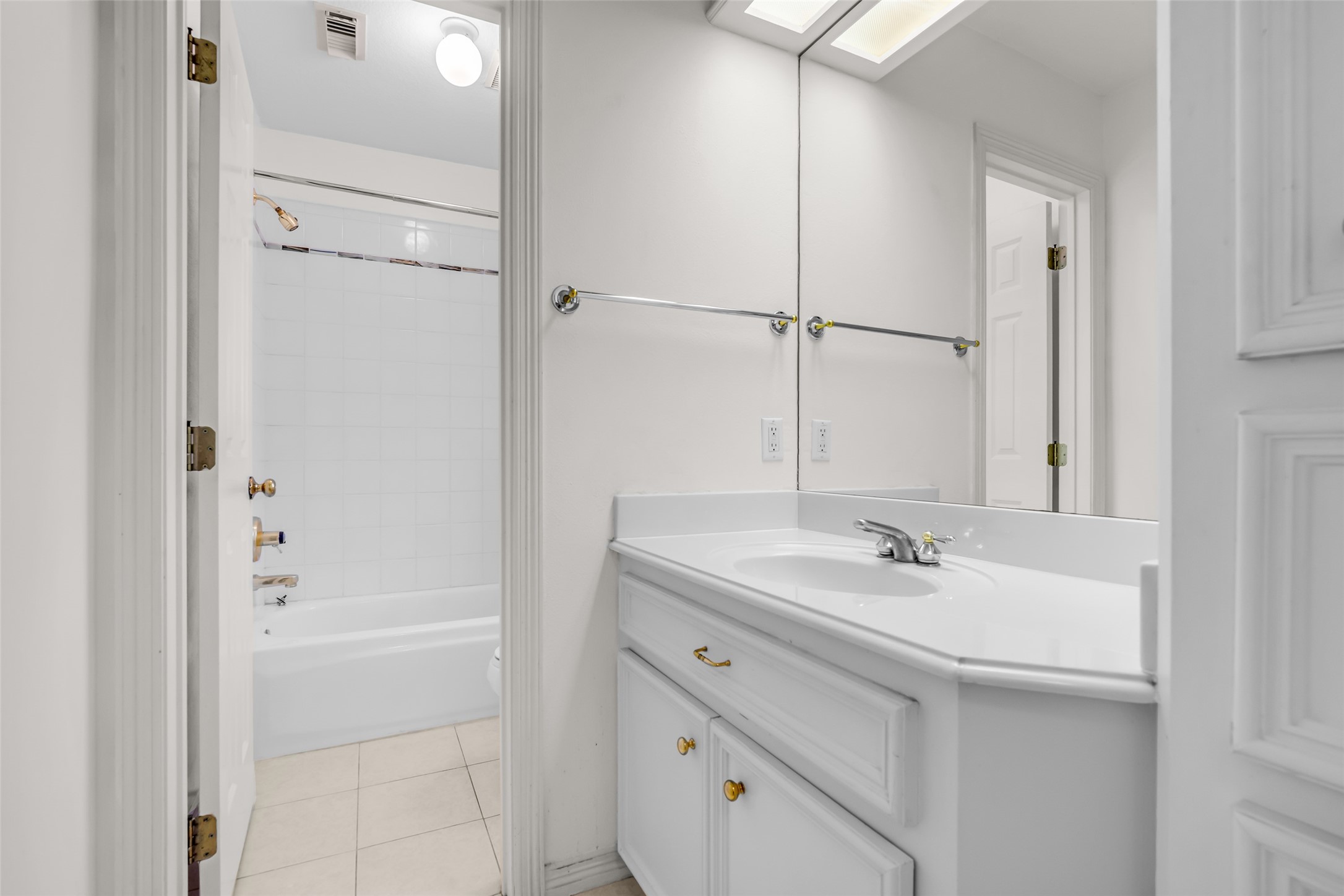 4916 Travis Street Houston, TX 77004 - Photo 21 of 27 a bathroom with a sink and a mirror with bathtub