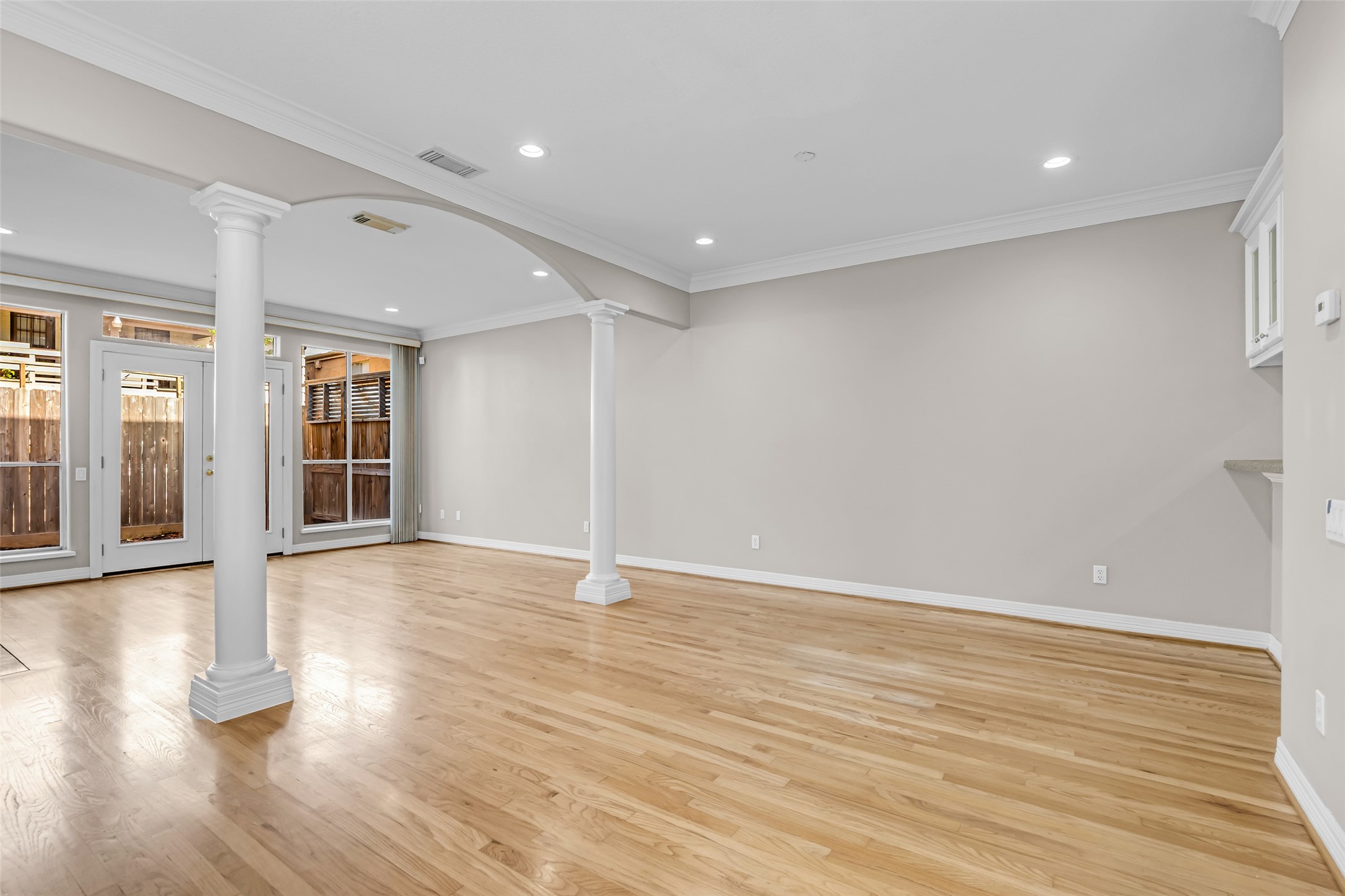 4916 Travis Street Houston, TX 77004 - Photo 6 of 27 wooden floor in an empty room with a window