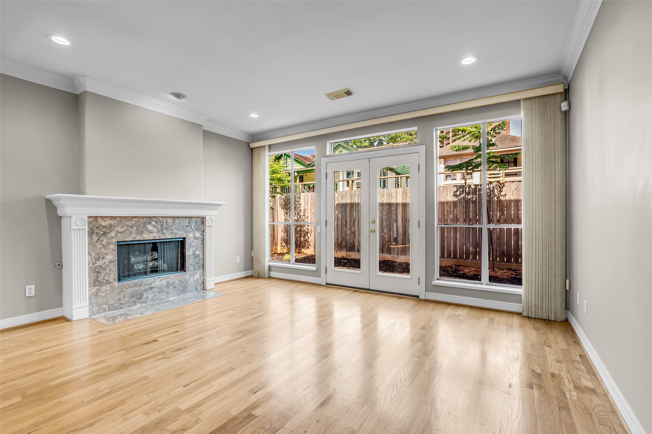 4916 Travis Street Houston, TX 77004 - Photo 7 of 27 a view of an empty room with window and fire place