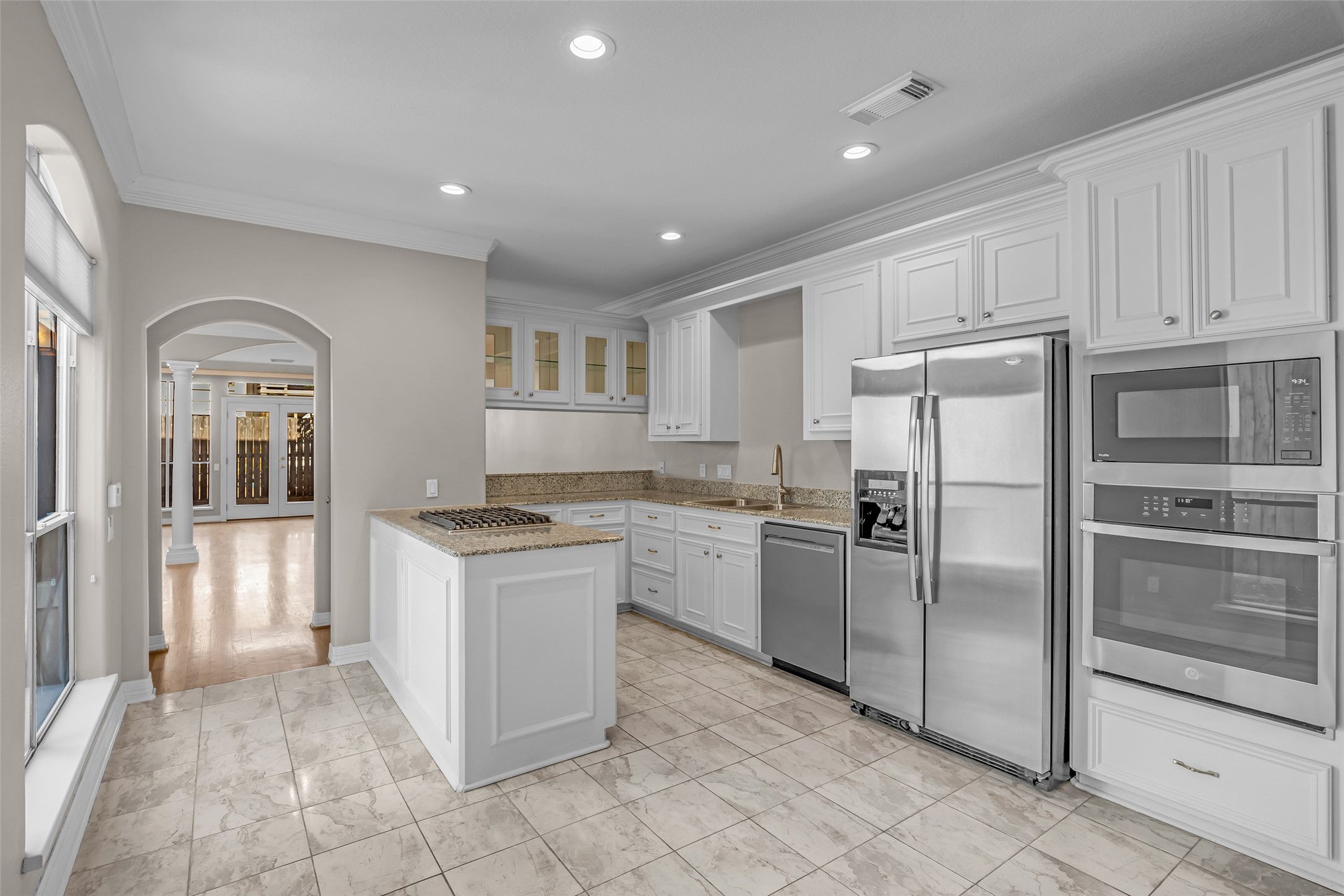 4916 Travis Street Houston, TX 77004 - Photo 9 of 27 a kitchen with granite countertop a refrigerator and a stove top oven