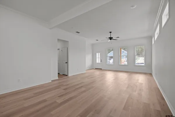 a kitchen with white cabinets and sink