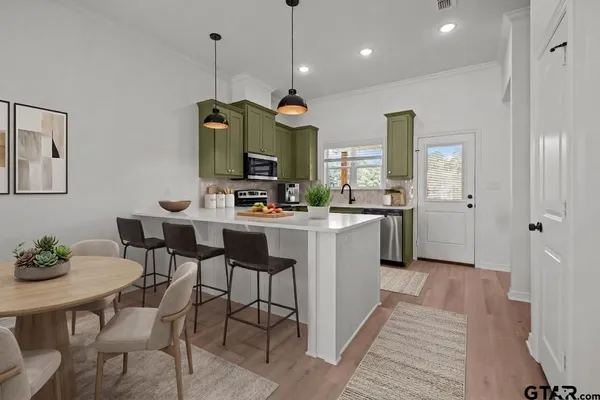 a kitchen with stainless steel appliances granite countertop a sink and a stove